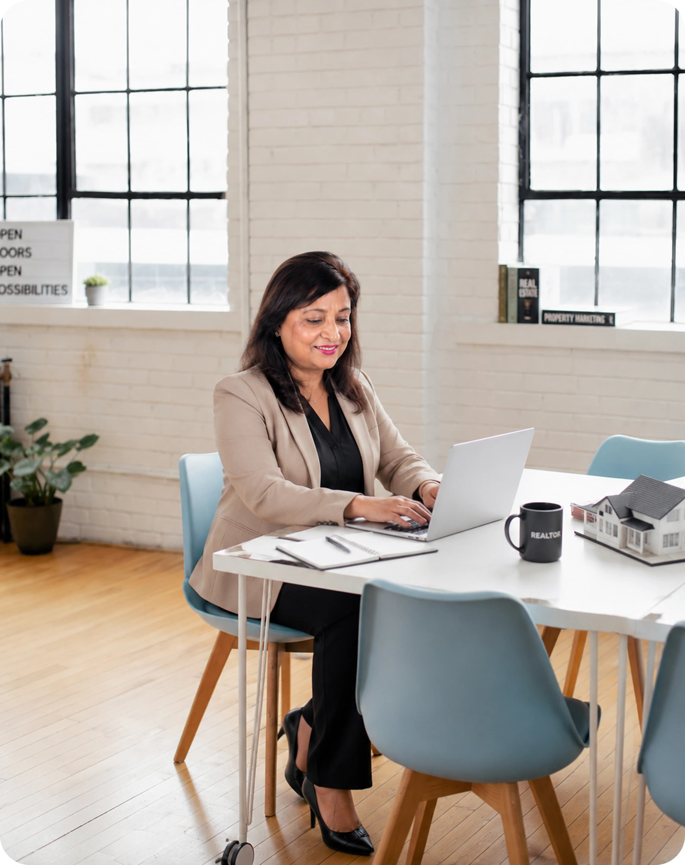 Saher Rafiq working at her desk with a laptop